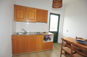 Apartment, 2 Bedrooms | Private kitchenette | Fridge, stovetop, electric kettle, cookware/dishes/utensils