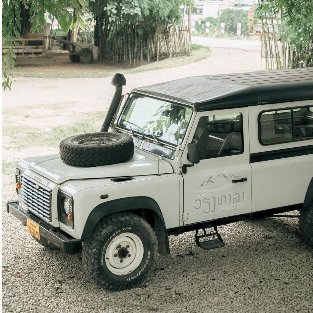 A white off-road vehicle parked on gravel.