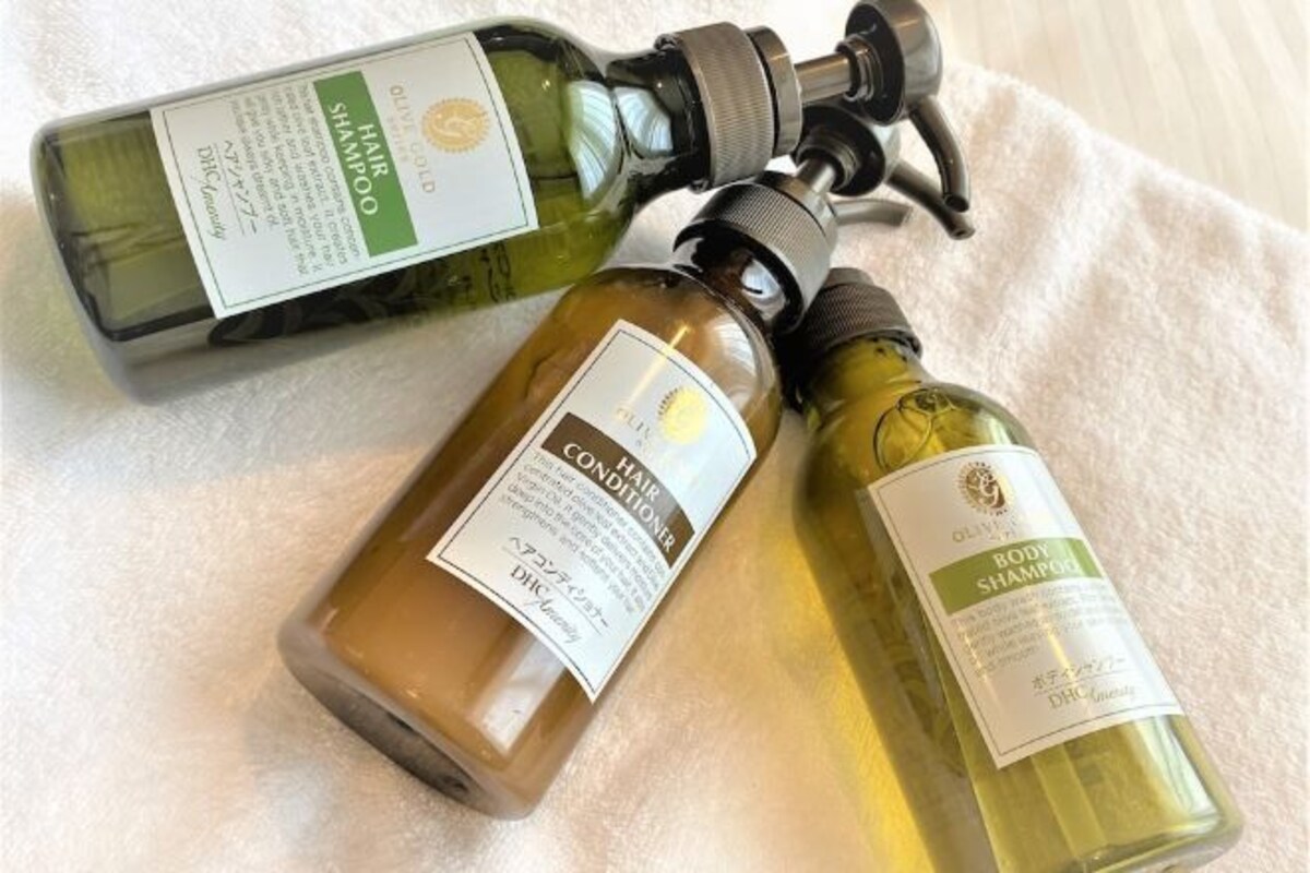 Two bottles of hair care products on a white towel.