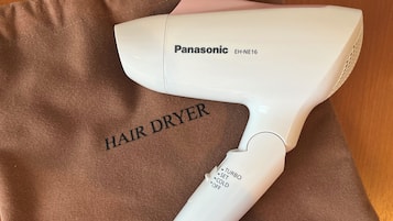 A Panasonic hair dryer with a brown fabric bag labeled "HAIR DRYER" and settings including "TURBO," "SET," "COLD," and "OFF."