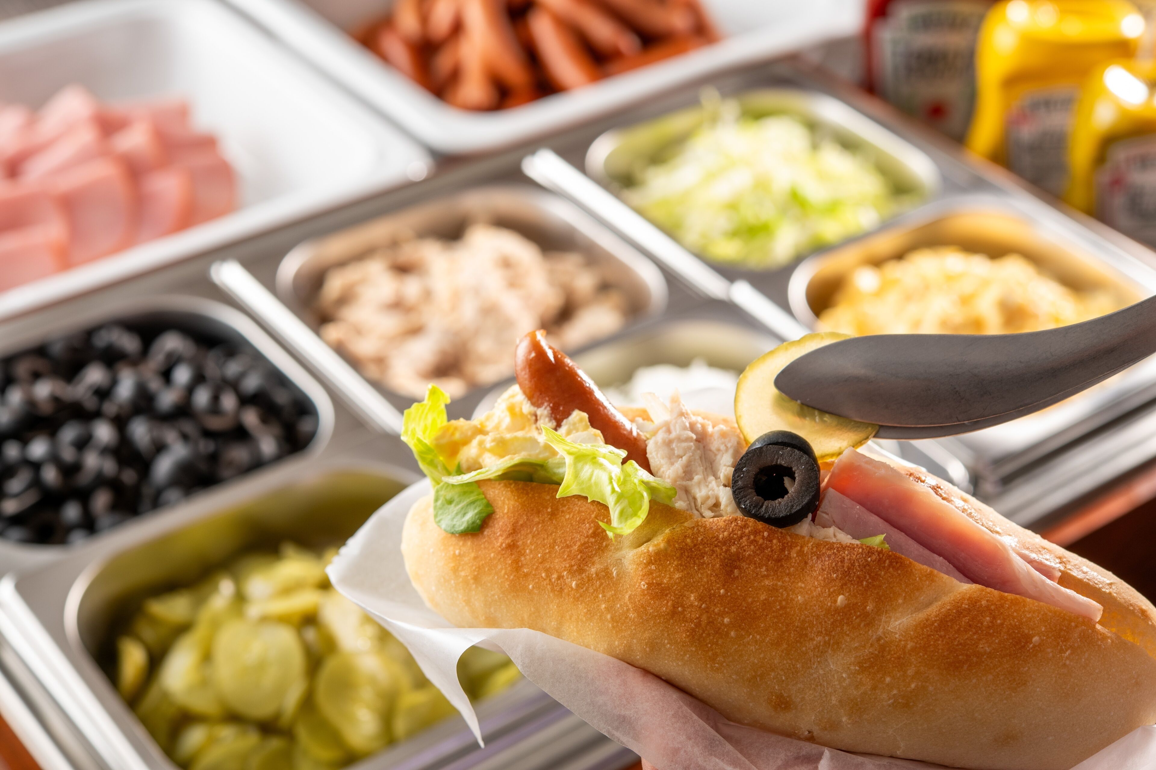 A sandwich with various toppings on a tray.