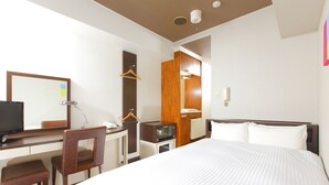 A hotel room with a bed, desk, chair, television, wardrobe, and a mirror. - Flexstay Inn Kawasaki-Kaizuka (Kawasaki)