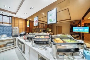 A buffet area with multiple food stations and a digital menu board. - Boinn Zhi Xuan Hotel（Nantong Tongzhou Coach Station Jianshe Lu ） (Nantong)