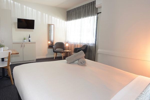 Executive Queen | Desk, blackout drapes, iron/ironing board, cribs/infant beds