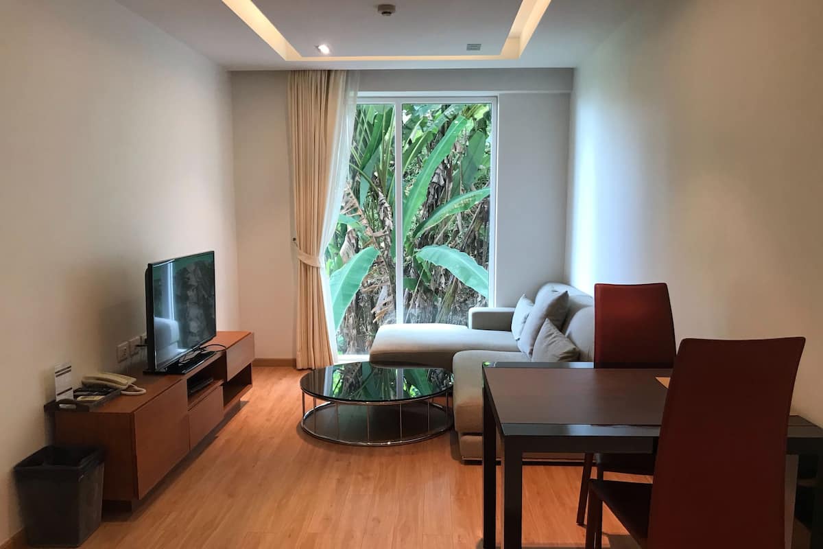 1 Bedroom Apartment Standard | Living area | 50-inch Smart TV with digital channels