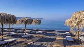 On the beach, sun-loungers, beach umbrellas, beach towels