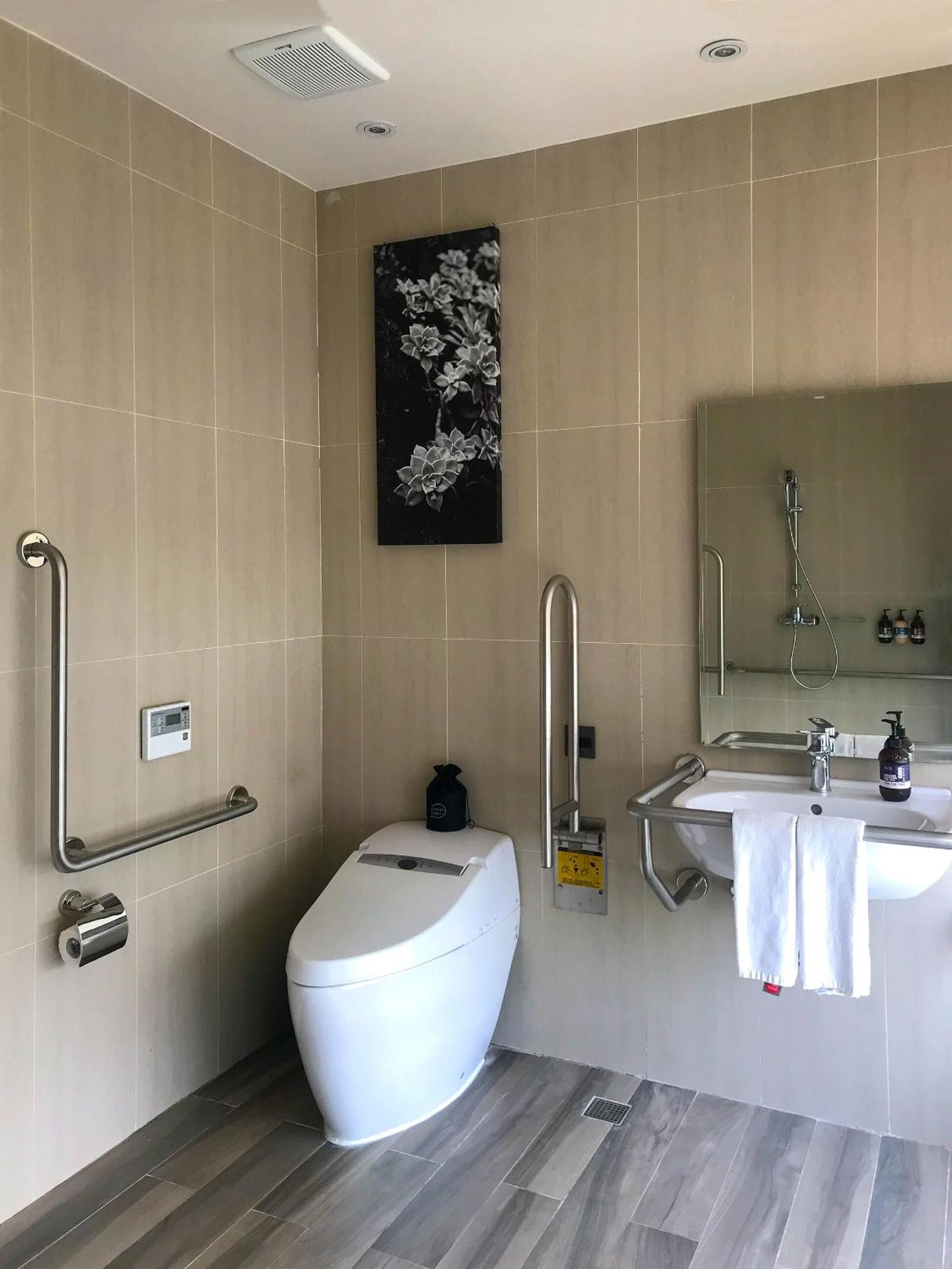 A modern bathroom with a toilet, bidet, and sink.