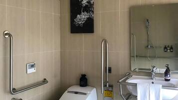 A modern bathroom with a toilet, bidet, and sink.