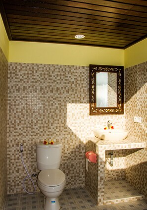 Un baño con inodoro, lavabo y espejo.