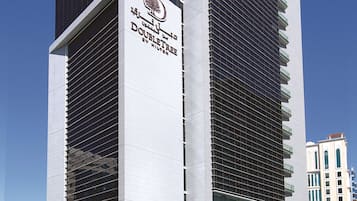 A modern building with a prominent sign for 'DoubleTree by Hilton'.