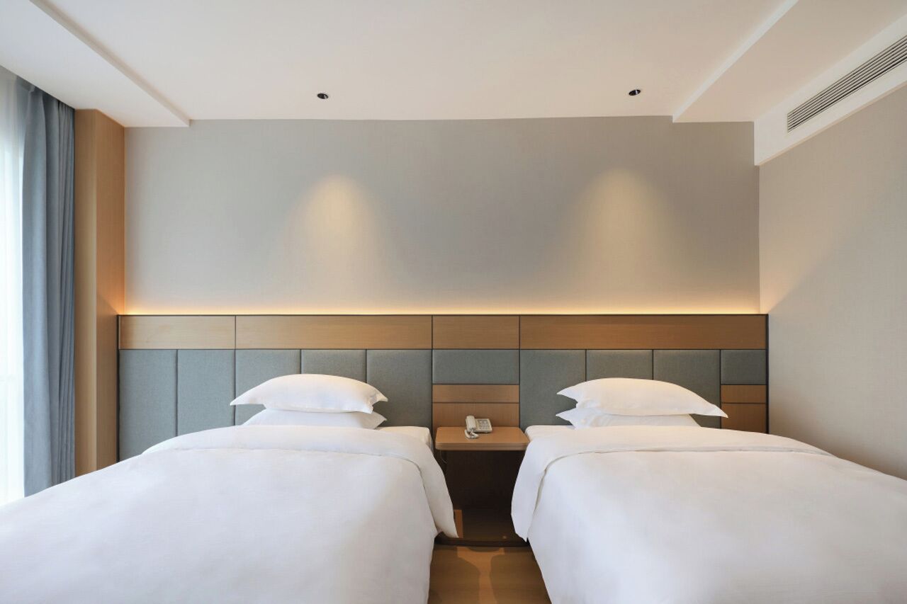 comfort twin room | premium bedding, down duvets, desk, laptop workspace