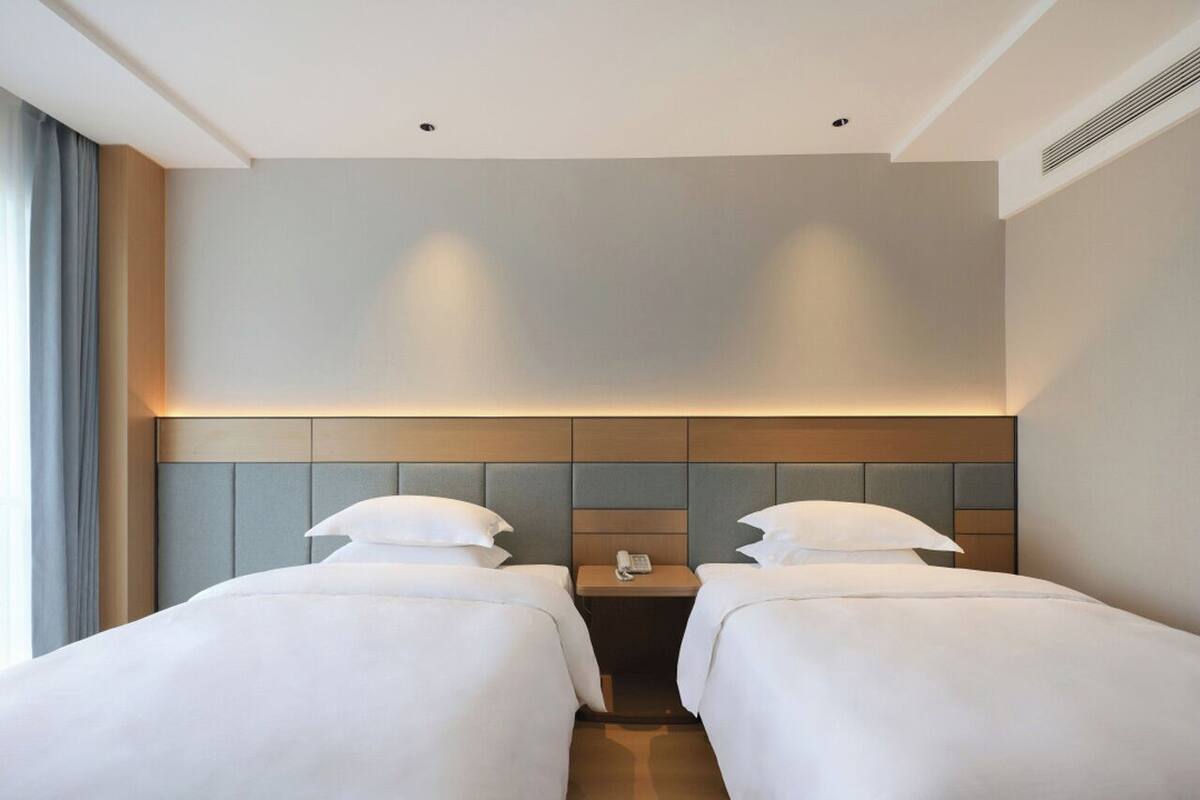 comfort twin room | premium bedding, down duvets, desk, laptop workspace