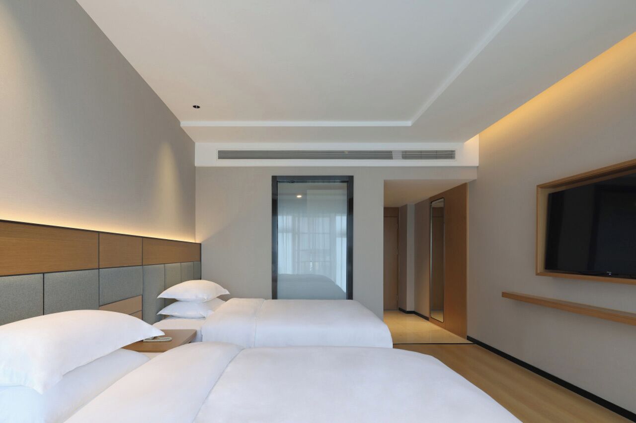 comfort twin room | premium bedding, down duvets, desk, laptop workspace