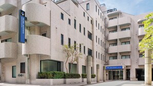 A modern hotel with a unique architectural design, featuring curved balconies and a tiled facade. - HOTEL MYSTAYS Iidabashi (Tokyo)