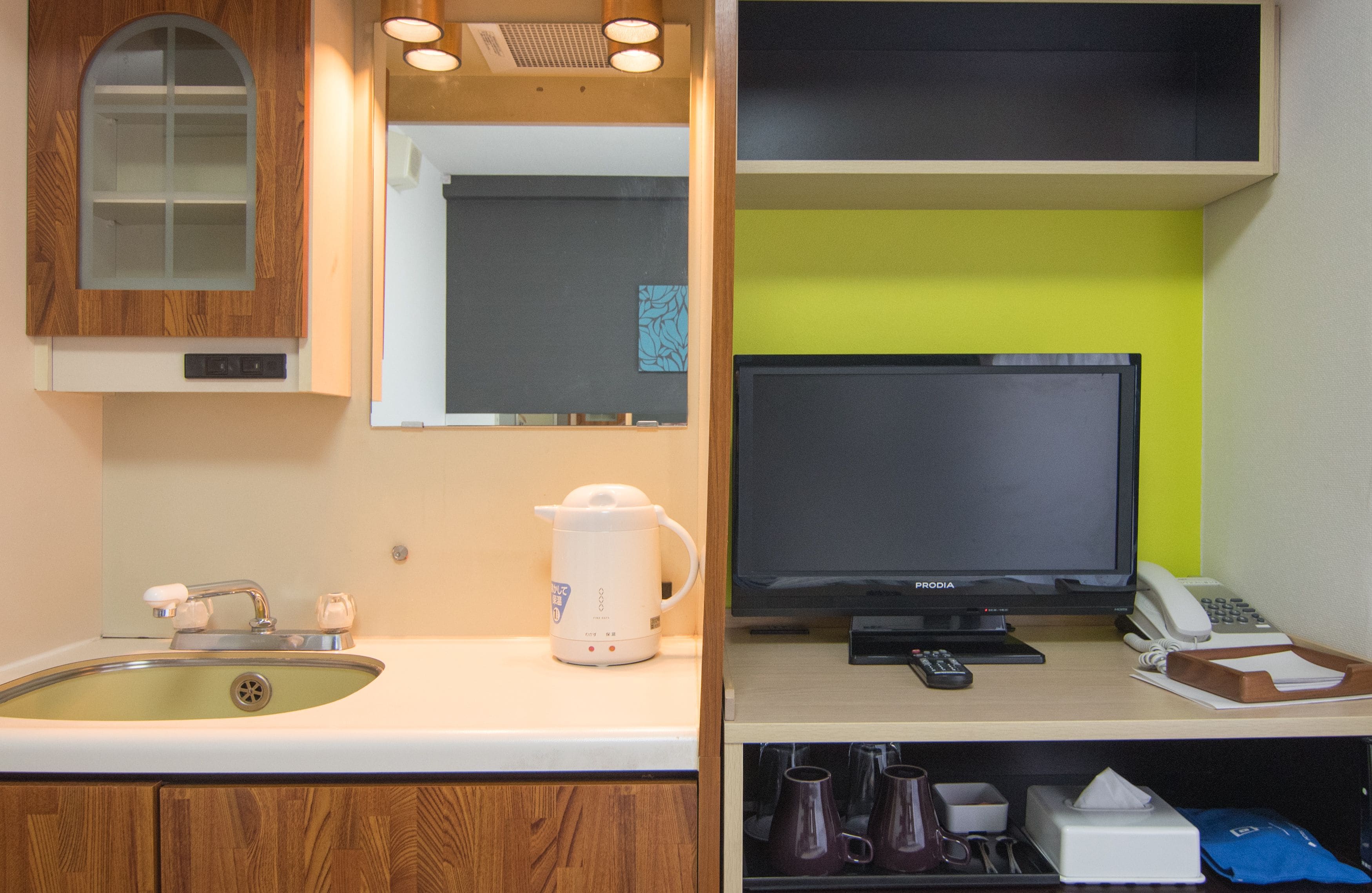 A kitchen with a sink, a coffee maker, a stove, and a microwave.