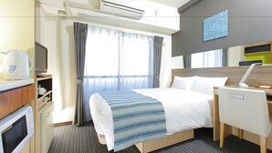 A hotel room with a bed, desk, chair, and a microwave. - Hotel MyStays Ueno Inaricho (Tokyo)