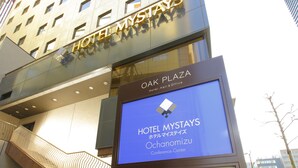 A modern hotel building with a sign reading "Hotel Mystays" and "Oak Plaza Hotel, Hall & Office." - Hotel MyStays Ochanomizu Conference Center (Tokyo)