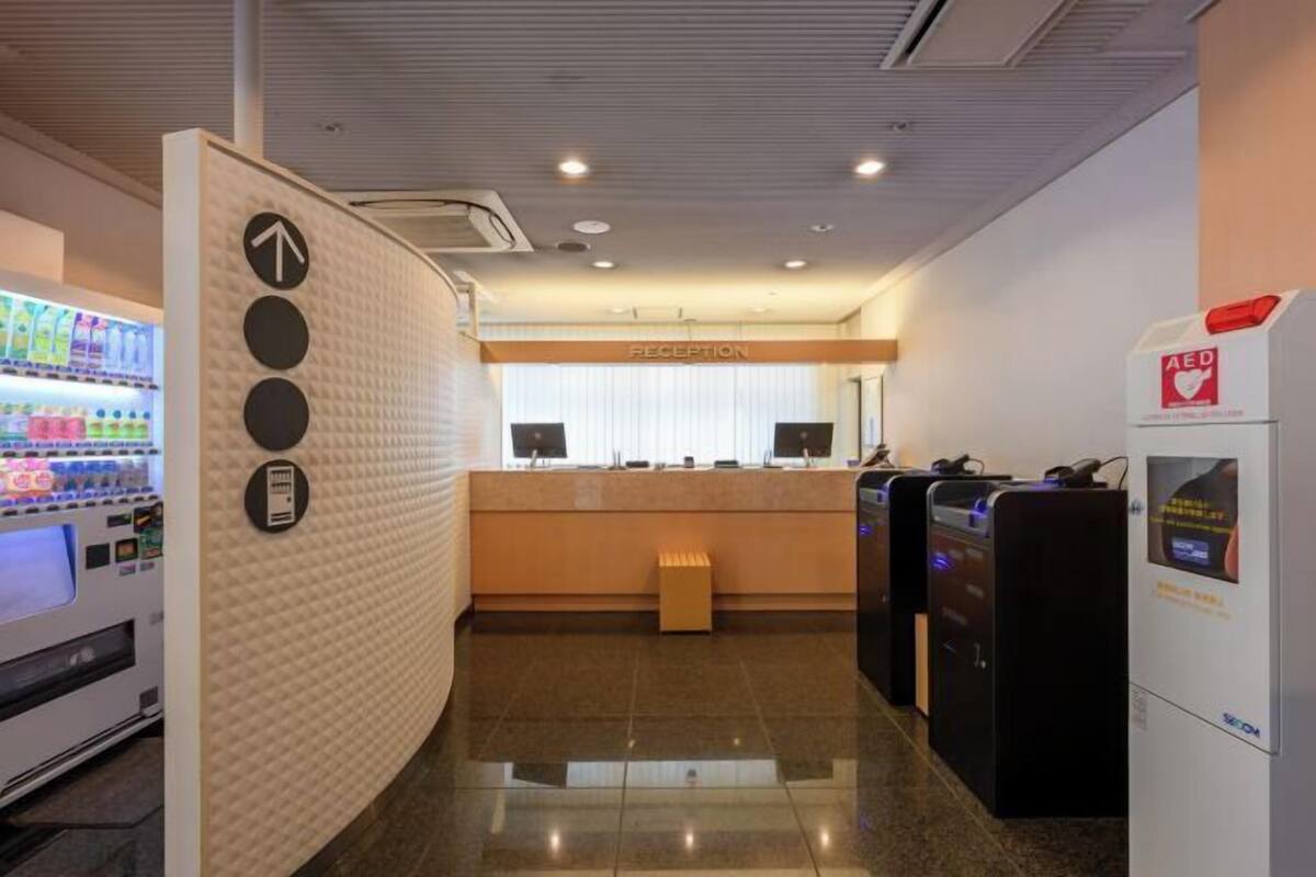 A reception area with a vending machine, a counter, and a ticket machine.