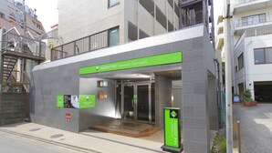 Un edificio moderno con un cartel que indica FlexStay Inn en Kawasaki-Ogawacho.