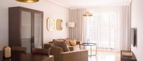 A modern living room with a dining area, a sofa, a TV, and a cabinet.