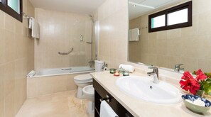 A modern bathroom with a bathtub, toilet, and sink. - Ona Valle Romano Golf & Resort (Estepona)