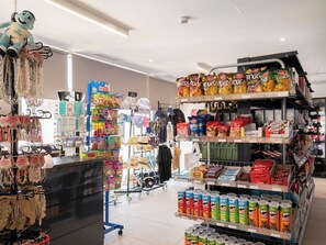 A store interior with various products on shelves, including snacks and beverages. - Ona Valle Romano Golf & Resort (Estepona)