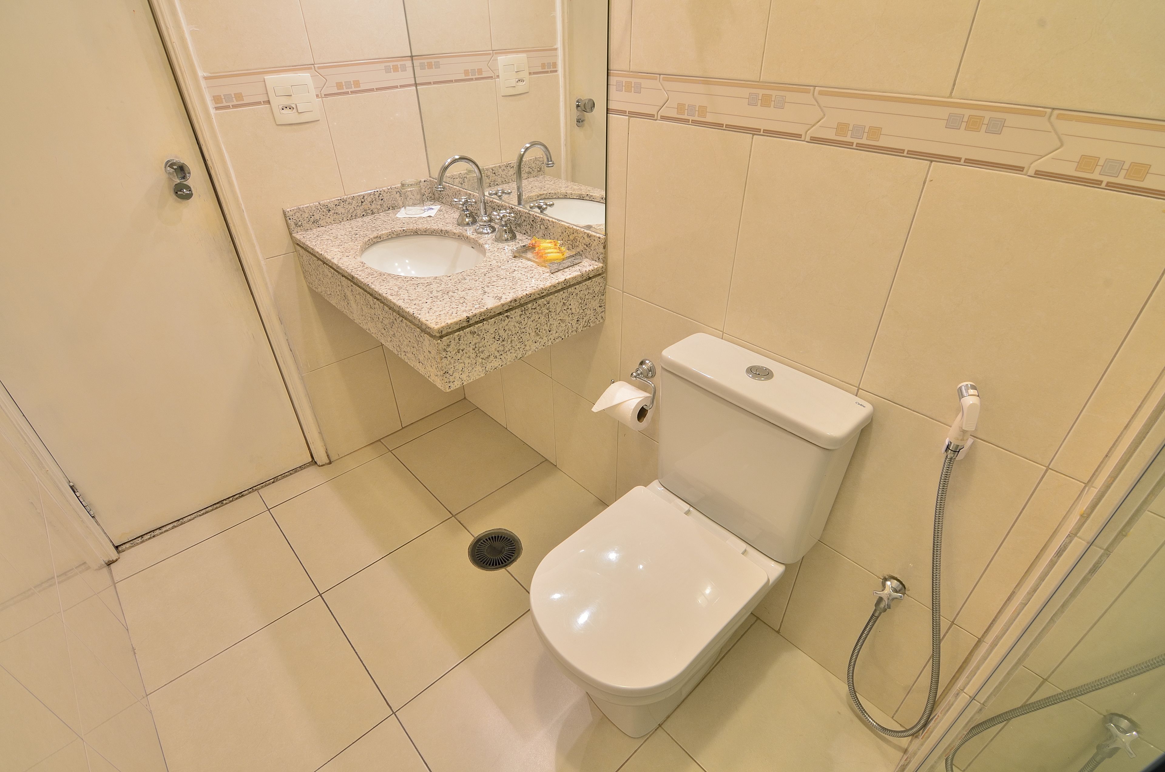 A bathroom with a sink, toilet, and shower.