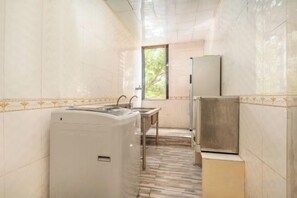 Une petite salle de bain étroite, avec un lavabo, un miroir et des toilettes.