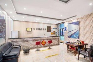A hotel lobby with a reception desk, seating area, and a large window. - Jilv Boutique Hotel (Guangzhou Shangxiajiu Pedestrian Street Xichang Subway Station) (GUANGZHOU)