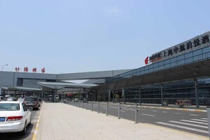 A modern building with a covered entrance and a clear sky.