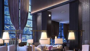 A modern hotel lobby with a high ceiling, large windows, and a seating area with tables and chairs. - Shanghai HongQiao Airport Hotel (Shanghai)