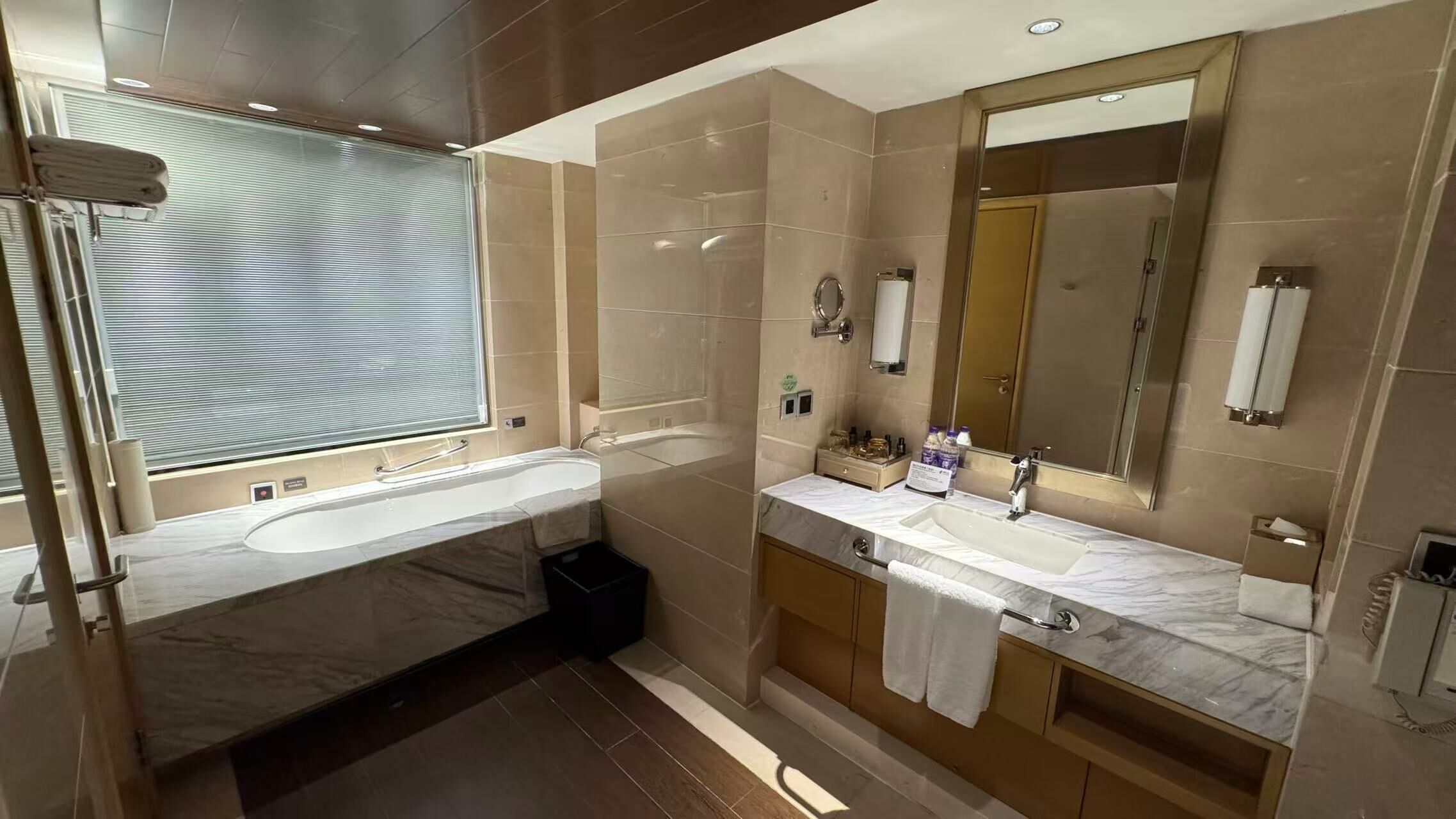 deluxe suite | bathroom | shower, slippers, towels