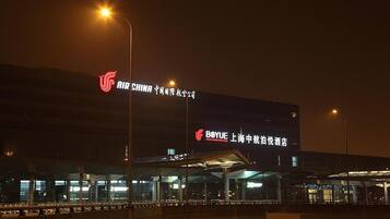 A modern building with illuminated signage for 'Air China' and 'Boyue' hotel.