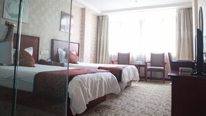 A hotel room with two beds, a desk, a chair, and a large window with curtains. - Greentree Inn Hefei Chaohu City Xiangyang Road Hot (Hefei)