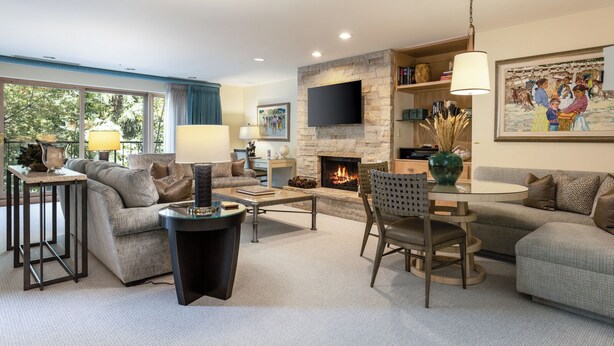 A modern living room with a fireplace, comfortable seating, and a flat-screen TV. - The Galatyn Lodge (Vail)
