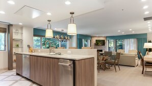 A modern kitchen with a central island, built-in appliances, and pendant lighting. - The Galatyn Lodge (Vail)