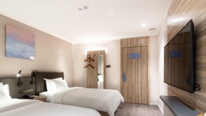 A hotel room with two beds, a TV, a painting, and a wooden wardrobe.