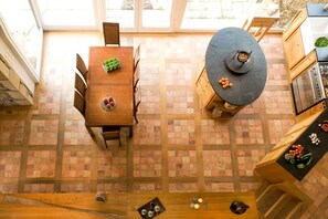 A kitchen with a brick floor, a wooden dining table, and a stone countertop. - La Villa du Golfe (Arradon)