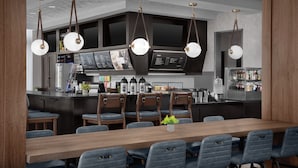 Een moderne keuken met een centraal eiland, barstoelen en hanglampen.