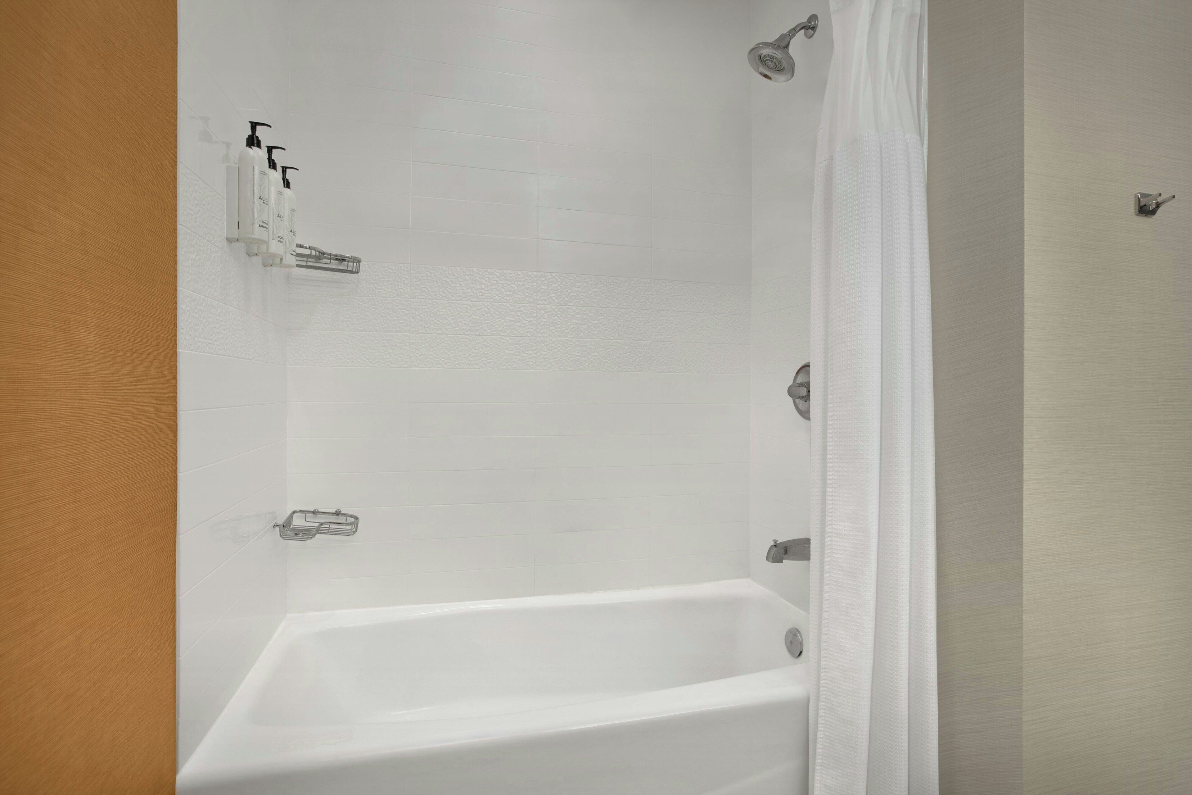 A bathroom with a bathtub, a shower, and a toilet.