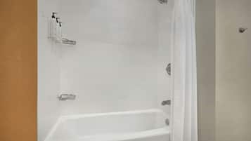 A bathroom with a bathtub, a shower, and a toilet.