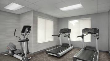 A fitness room with treadmills, an elliptical, and a stationary bike.