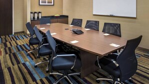 A conference room with a long table, six chairs, a whiteboard, and a coffee station. - Fairfield Inn & Suites Wilmington New Castle (New Castle)
