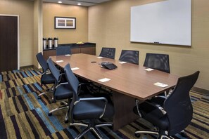 A conference room with a long table, six chairs, a whiteboard, and a coffee station. - Fairfield Inn & Suites Wilmington New Castle (New Castle)