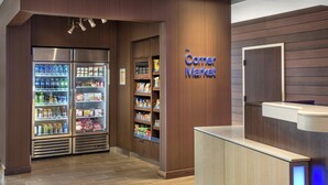 A corner market with refrigerated beverage displays and snack shelves. - Fairfield Inn & Suites Wilmington New Castle (New Castle)