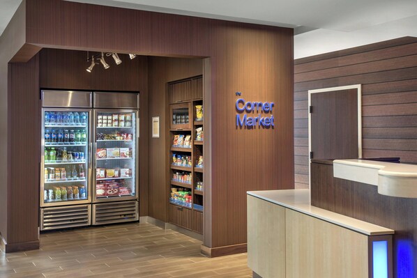 A corner market with refrigerated beverage displays and snack shelves. - Fairfield Inn & Suites Wilmington New Castle (New Castle)