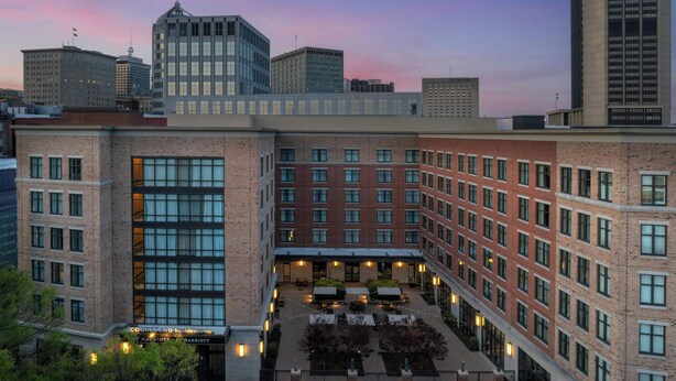 A multi-story hotel with a courtyard, large windows, and a brick facade. - Residence Inn by Marriott Richmond Downtown (Richmond)