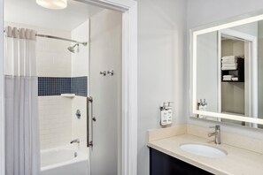 A bathroom with a bathtub, shower, and sink. - Staybridge Suites Albany Wolf Rd-Colonie Center by IHG (Albany)