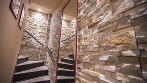 A staircase with stone walls and a handrail. - Residence Bouttau (Cannes)