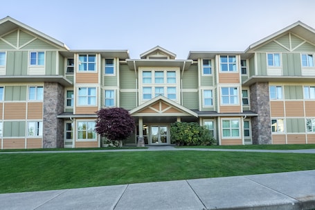 A multi-story building with a symmetrical facade, large windows, and a central entrance.